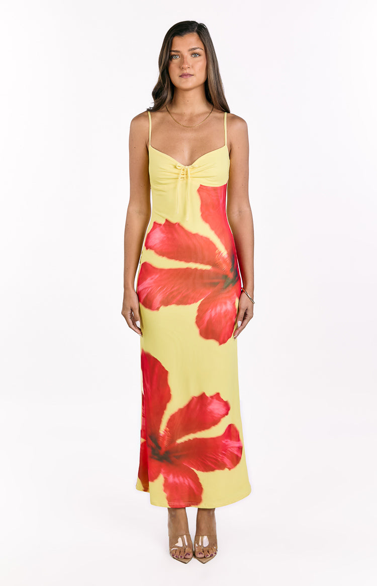 Yellow maxi dress with red hibiscus print, designed with a tie-front sweetheart neckline and thin spaghetti straps