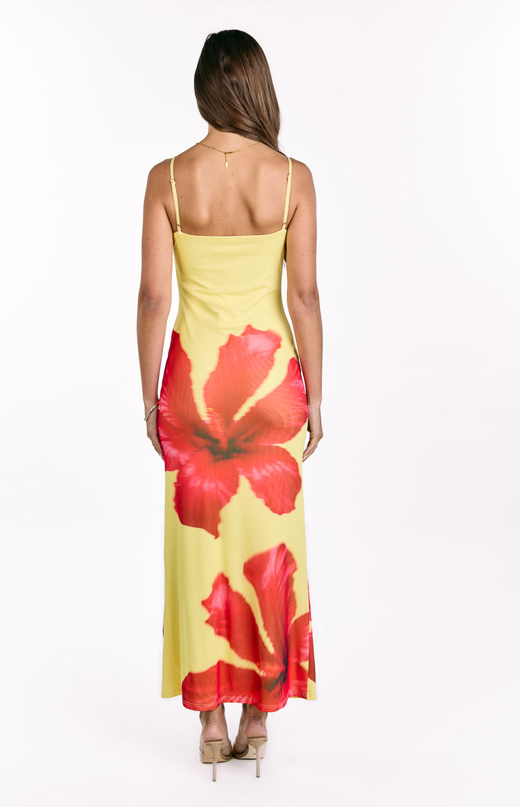 Rear view of the yellow hibiscus print maxi dress with a straight back neckline and delicate spaghetti straps