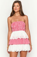 model is wearing a red and white strapless mini dress with elasticated bodice and tiered skirt detailing 