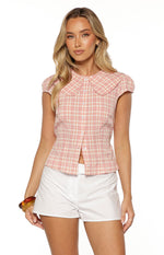 Front view of a pink plaid top with a Peter Pan collar, short puff sleeves, and a button-front closure