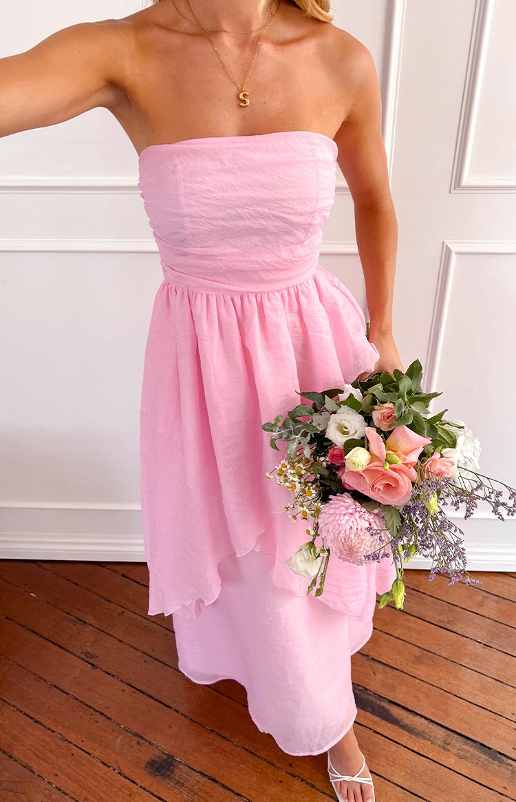 Close-up of the ruched strapless bodice, gathered waist, and layered pink maxi dress skirt with crinkled texture