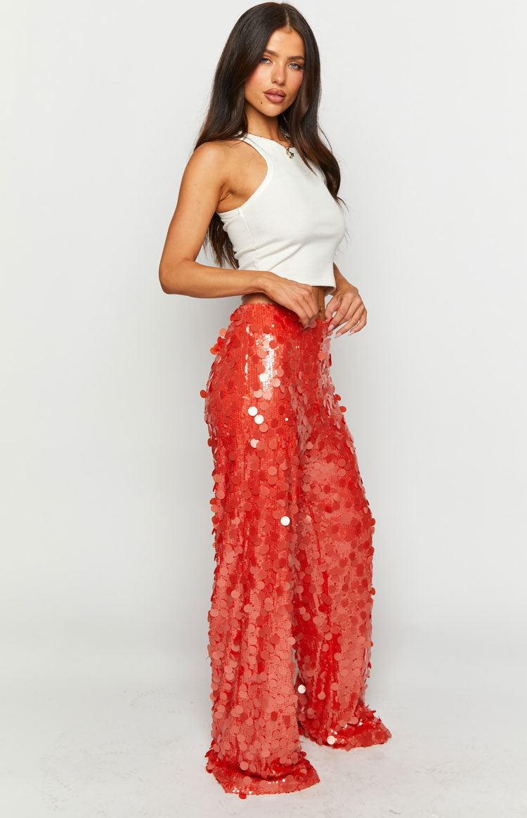 Side view of orange sequin wide-leg pants with a high waist and full sequin coverage