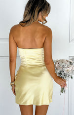 Rear view of a yellow satin strapless mini dress with a ruched corset-style bodice and side zipper