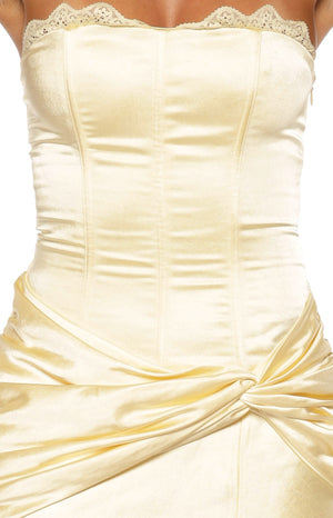 Close-up of the yellow satin strapless bodice with lace trim, corset seaming, and ruched twist waist detail