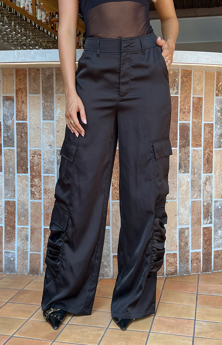 Beginning Boutique Satin Sapphire Black Cargo Pants black satin relaxed wide-leg cargo pants with side pockets and ruched lower leg