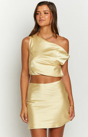 Front view of a yellow satin mini skirt with a smooth finish and a slight A-line cut