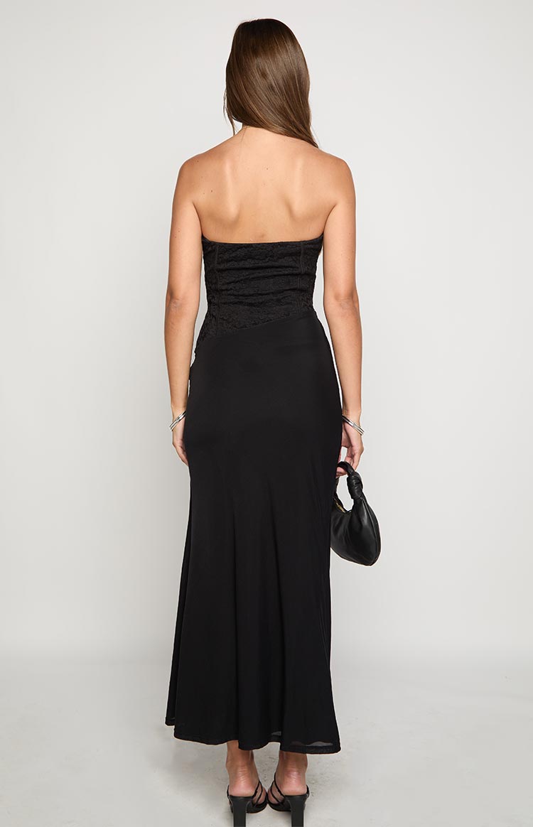 Rear view of a black strapless maxi dress with a lace corset bodice and flowing skirt
