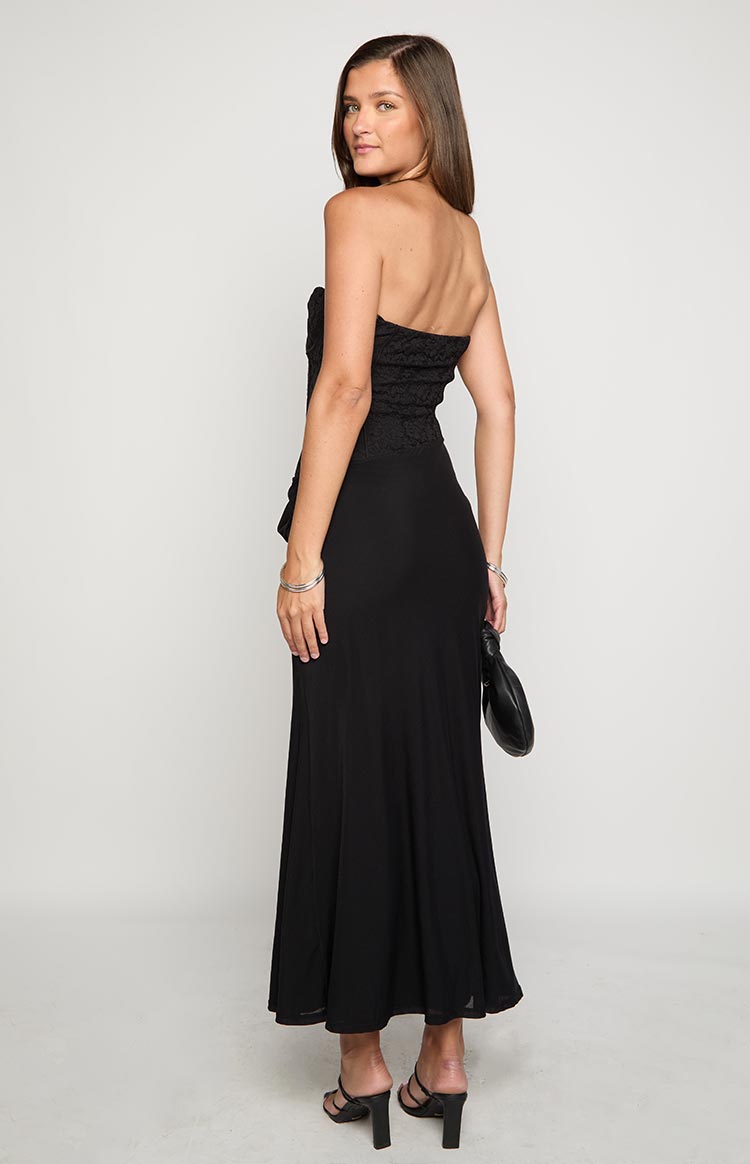 Rear-side view of a black strapless maxi dress with a lace-textured corset bodice and a smooth, flowing skirt