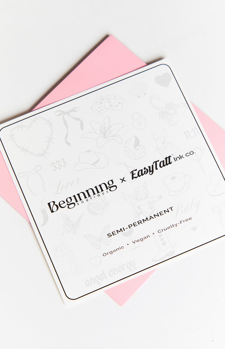 White sheet of semi-permanent tattoos featuring various line art designs and 'Semi-Permanent Organic Vegan Cruelty-Free' text
