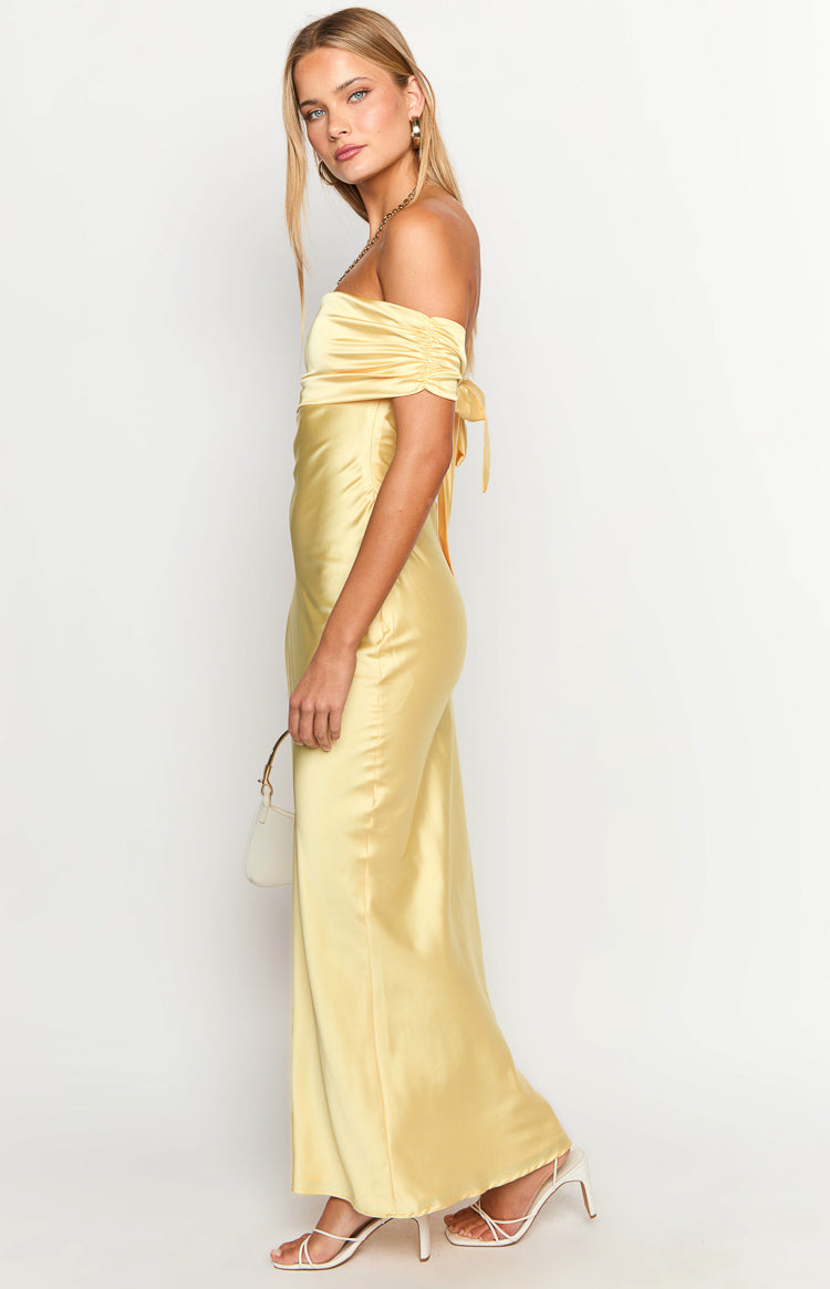 Side view of a yellow satin off-the-shoulder maxi dress with ruched sleeves and tie details