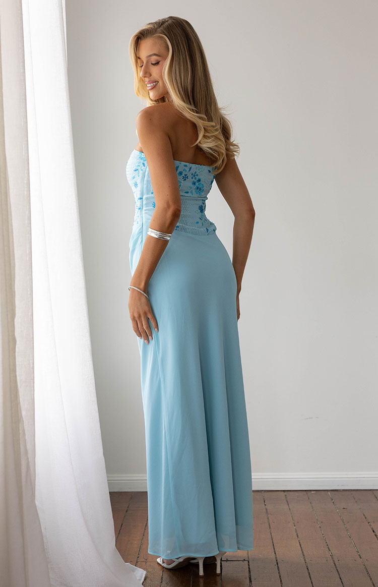 Rear side view of the serenity blue strapless maxi dress, with a beaded floral bodice and smocked back