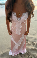 Pink satin maxi dress with white lace trim on the V-neckline and vertical lace panels down the front