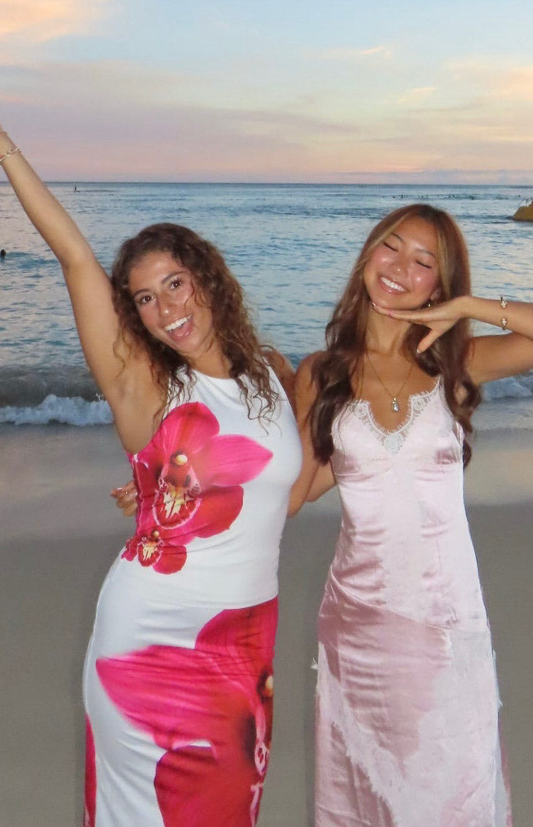 Pink satin maxi dress with white lace V-neck trim, lower skirt wet and clinging