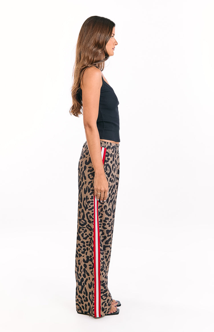 Side view of leopard print wide-leg pants with a red and white racer stripe