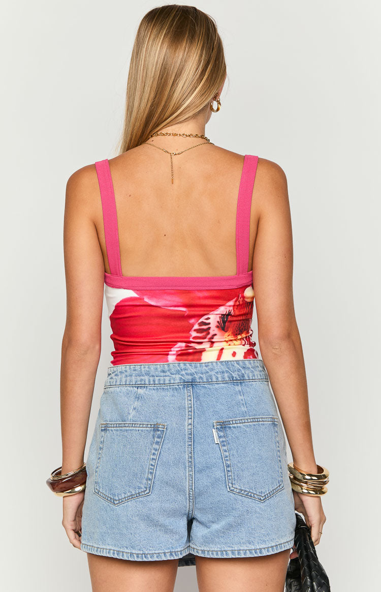 Rear view of a fitted cami with fuchsia pink ribbed straps and trim, featuring a white and red orchid print