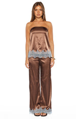 Full length view of brown satin wide-leg pants with light blue scalloped lace trim at the hem