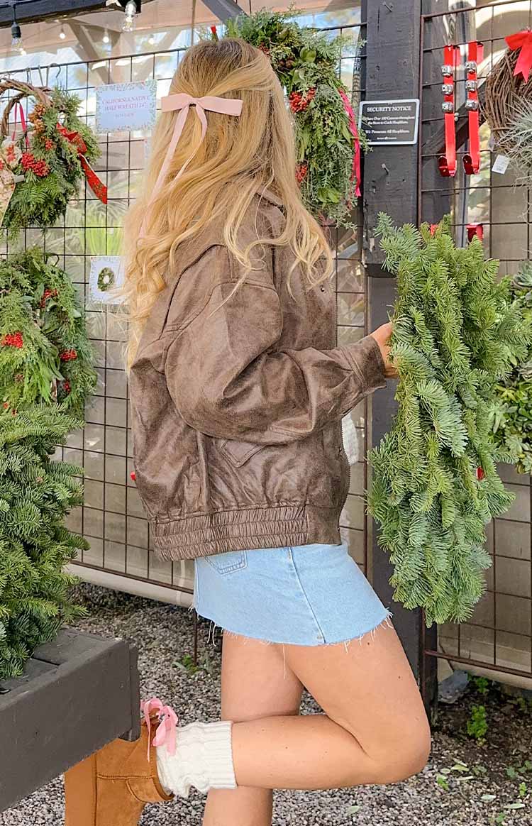 Side view of a light blue low-rise denim mini skirt with a raw hem
