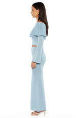 Side view of the blue shimmery knit maxi skirt, highlighting the fitted silhouette and subtle flare