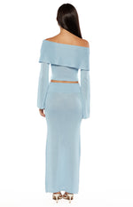 Rear view of a light blue shimmery knit maxi skirt with a wide waistband and side slit