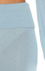 Close-up of the blue knit skirt's folded waistband and fine shimmery texture