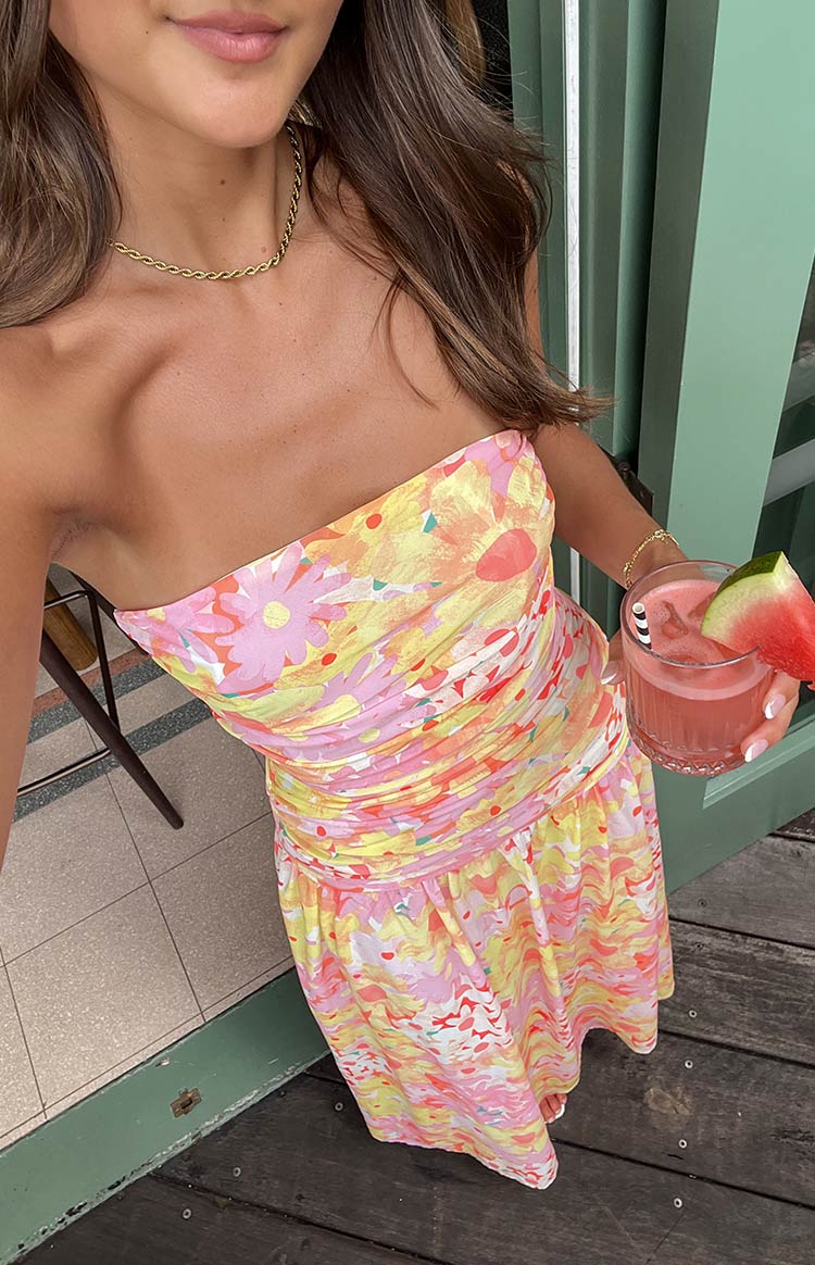 Close-up of the strapless yellow floral maxi dress with a ruched bodice