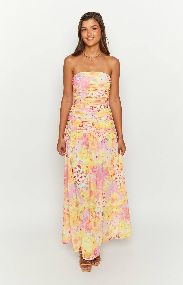Vibrant yellow floral print strapless maxi dress with a ruched bandeau bodice and a flowing skirt