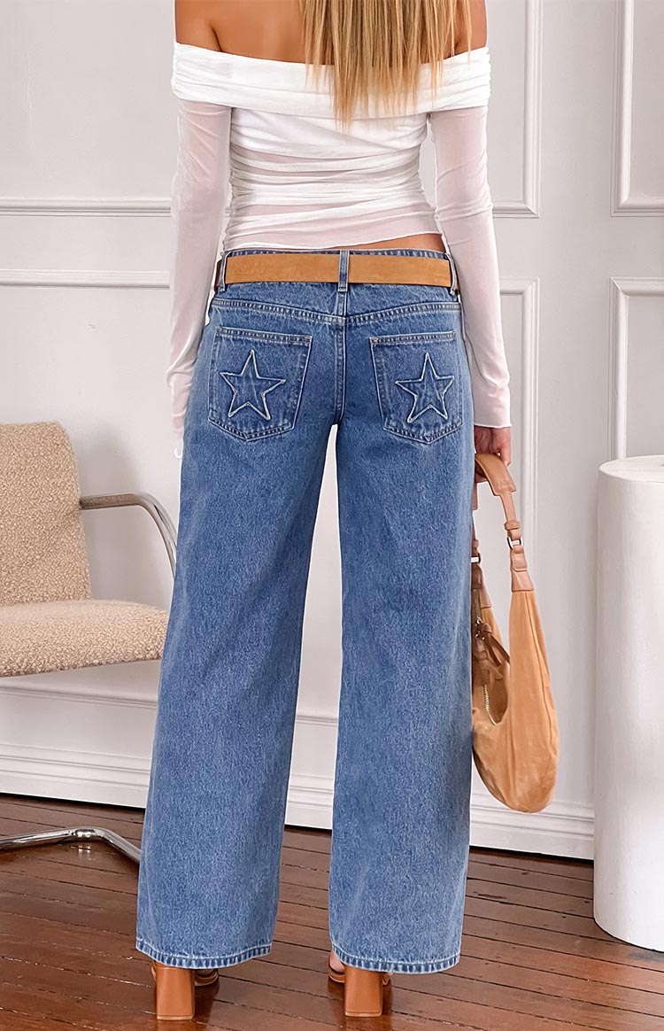 Rear view of a white mesh off-shoulder top with long sleeves and gathered detail on the back