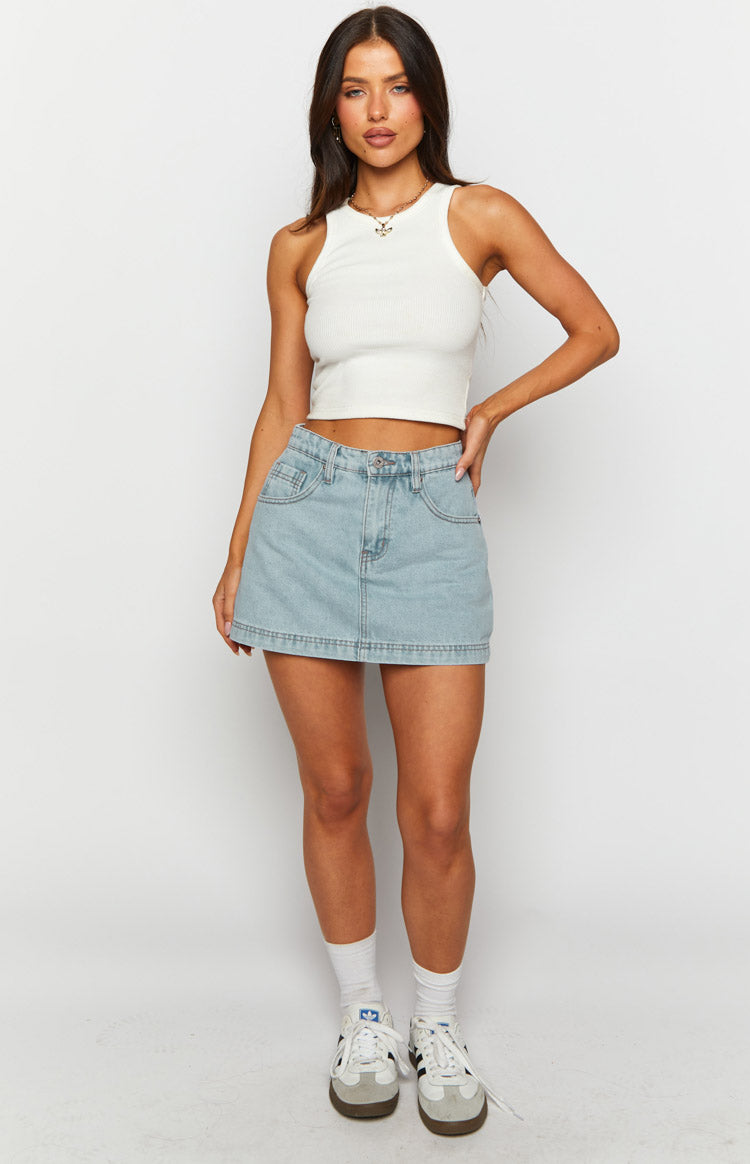 Light wash denim mini skort with front pockets, belt loops, and a straight hem