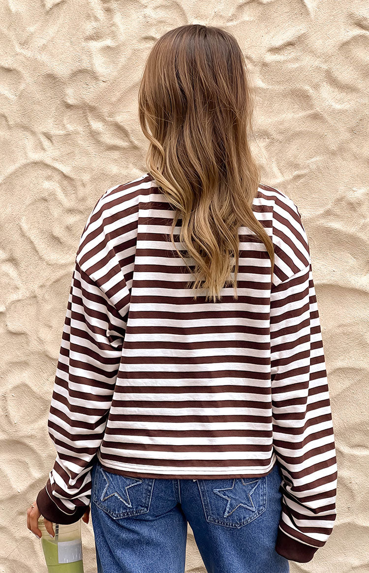 Rear view of a chocolate and white striped long sleeve top with a relaxed fit and cropped hem