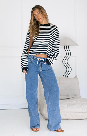 Full view of the navy and white striped long sleeve top with a crew neck, long cuffed sleeves, and relaxed fit