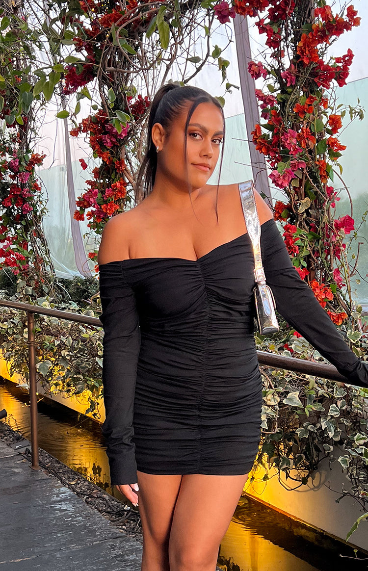 Black off-shoulder long sleeve mini dress with a sweetheart neckline and all-over ruching