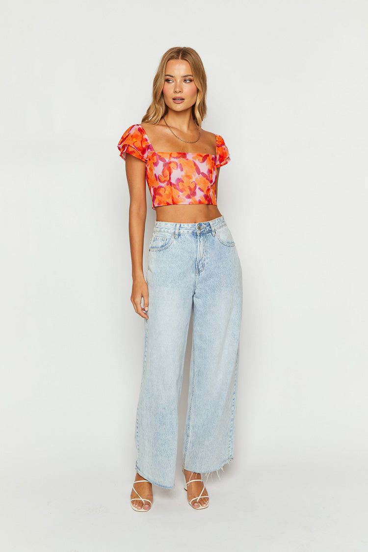 Front view of an azalea pink print crop top with a square neckline and short puff sleeves