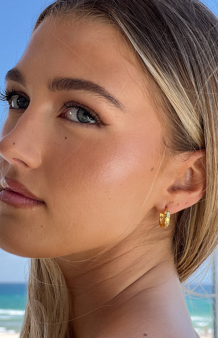 Beginning Boutique Stardust Gold Hoop Earrings gold hoop earrings with star and moon details