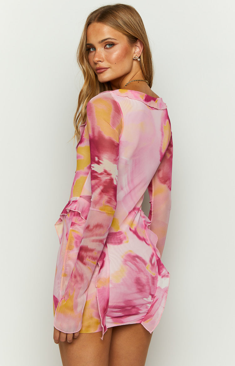 Rear side view of the pink floral mesh mini dress with long sleeves and ruffled trim detail