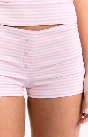Detail shot of the front of the pink and white striped shorts with a decorative three-button placket