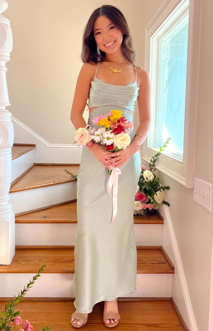Sage satin maxi dress with a draped cowl neckline, delicate spaghetti straps, and side waist cutouts