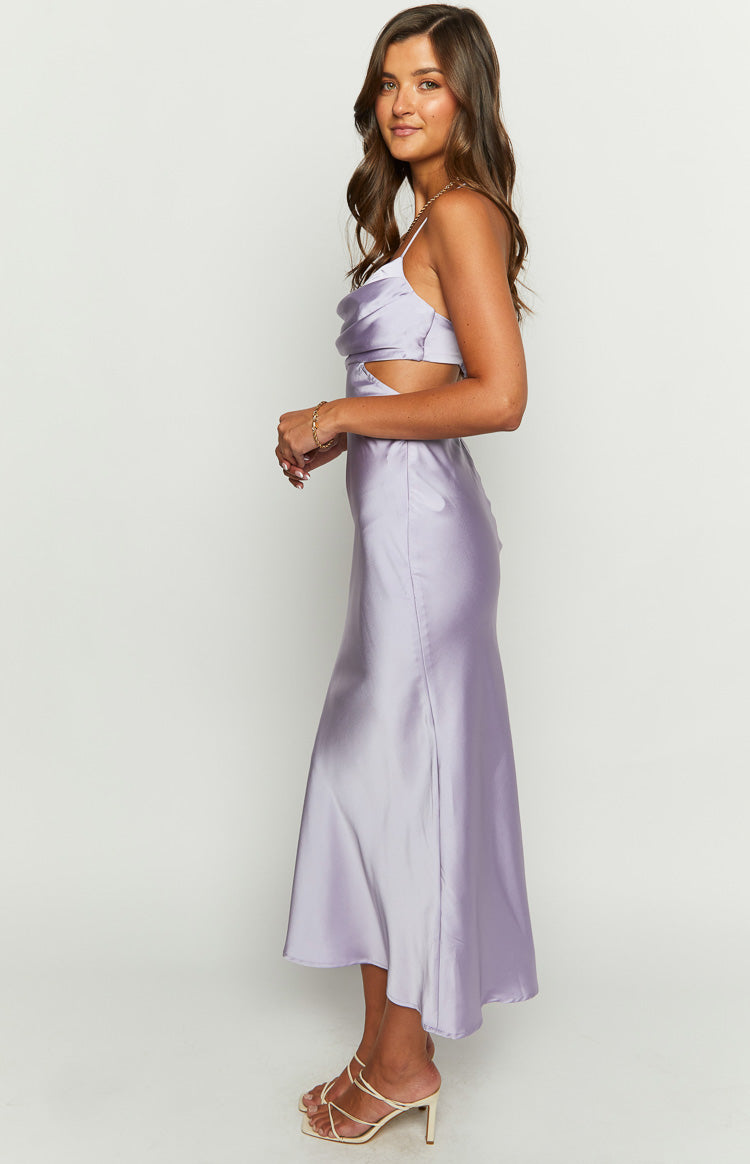 Side view of a lilac satin maxi dress showing the cowl neckline, spaghetti straps, and side waist cutouts