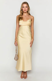 Yellow satin maxi dress with a draped cowl neckline and prominent side waist cutouts