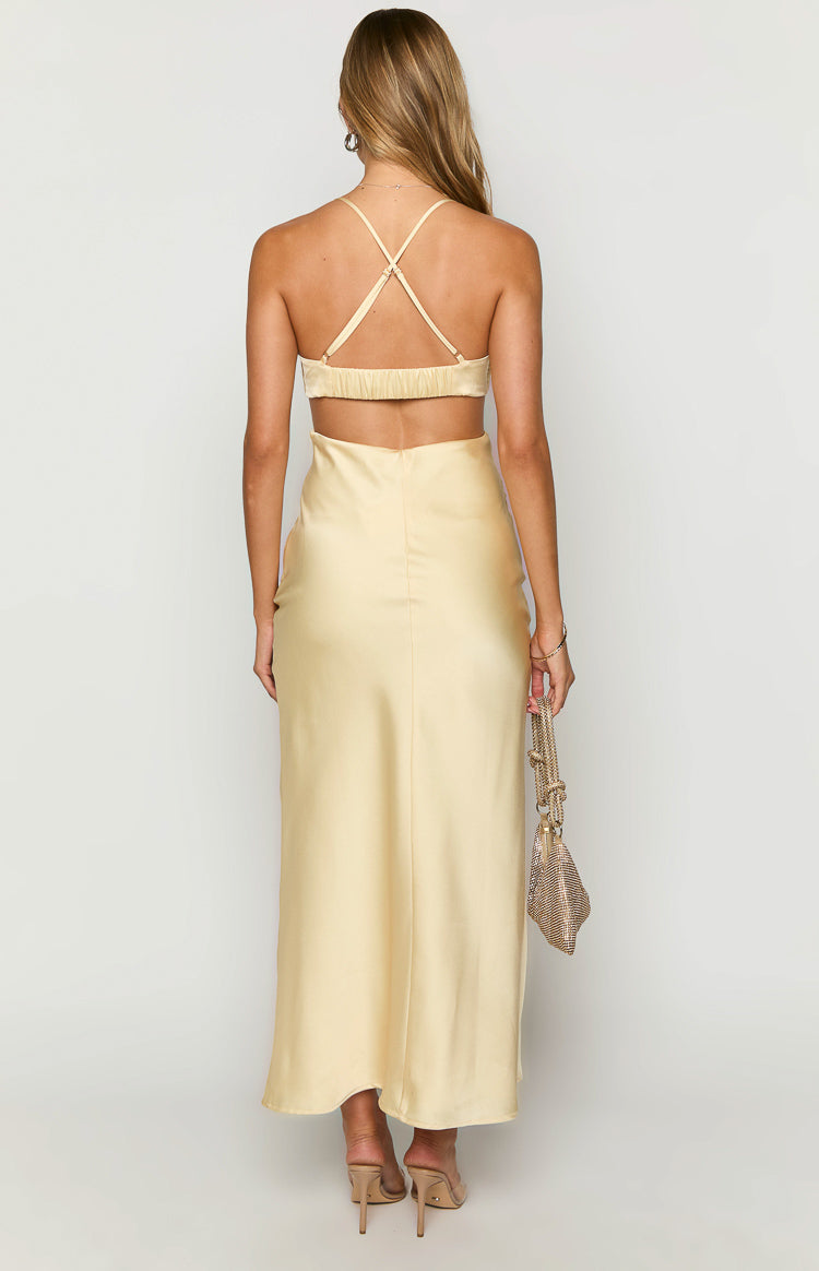 Rear view of a yellow satin maxi dress with criss-cross spaghetti straps, shirred upper back, and large lower back cut-out
