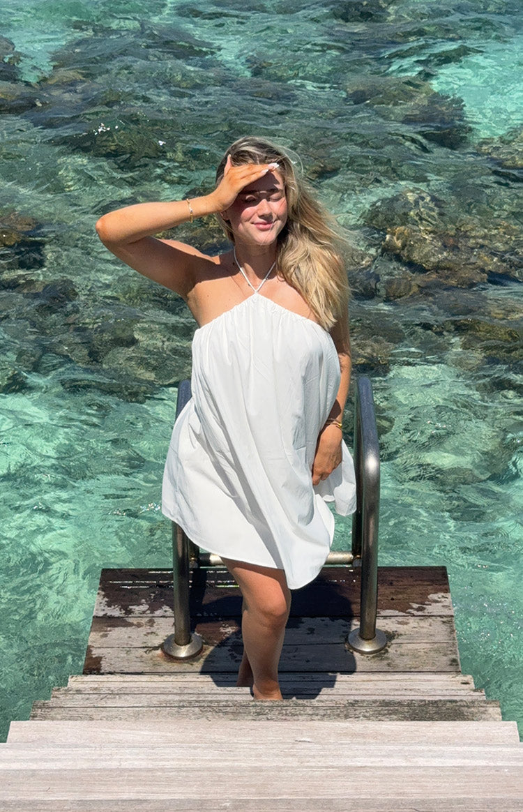 White halter mini dress with a gathered neckline and a loose, flowy silhouette