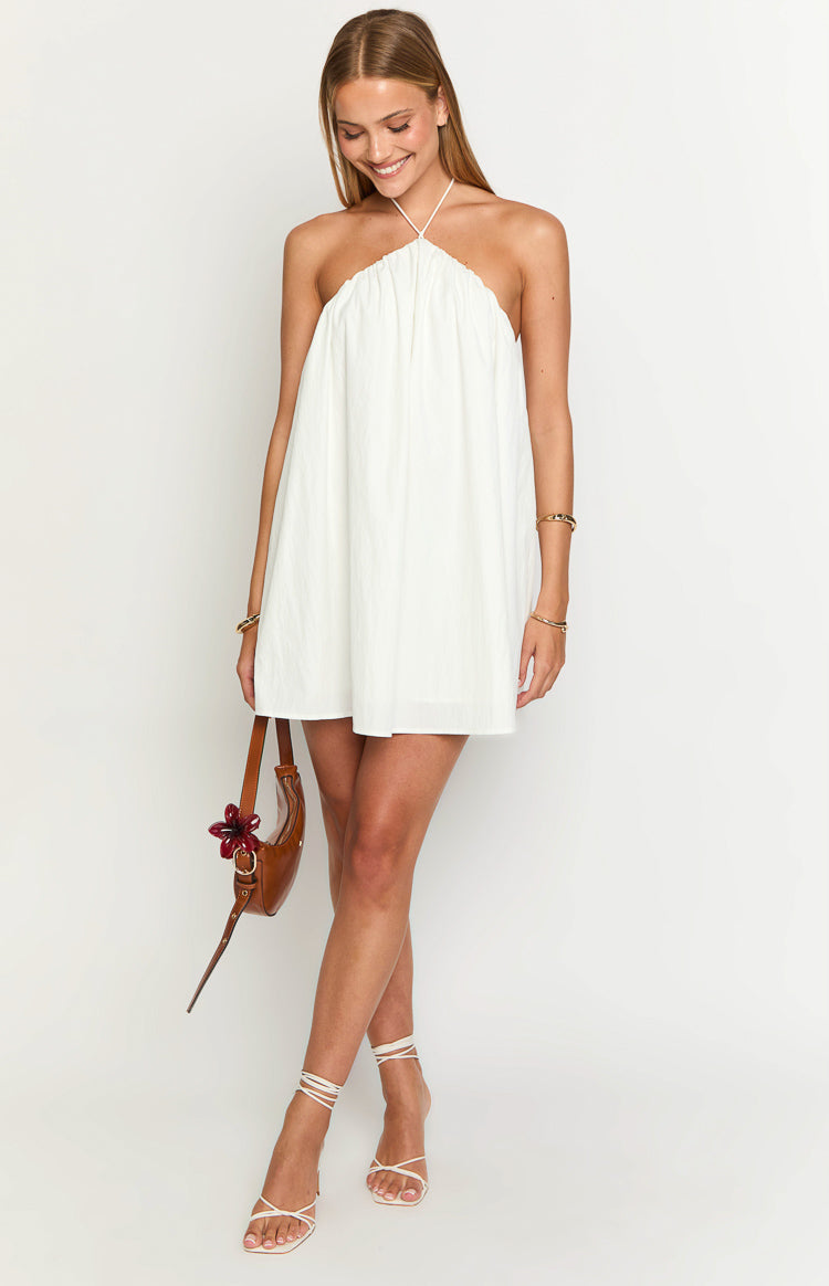 Front view of a white halter mini dress with a gathered bust and a loose, voluminous puff silhouette