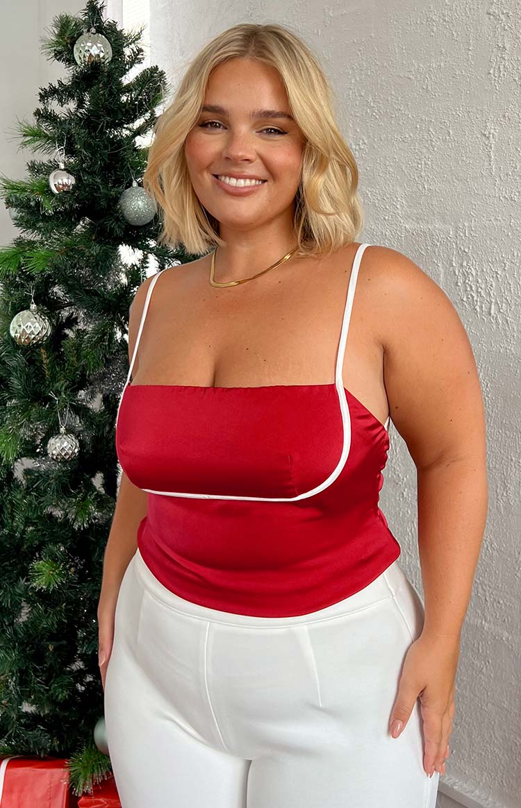 Red satin top with a square neckline, thin white spaghetti straps, and white piping detail along the bust and hem