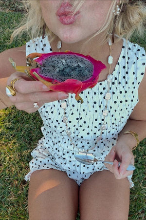 White polka dot shorts with a ruffled hem and lightweight cotton blend fabric