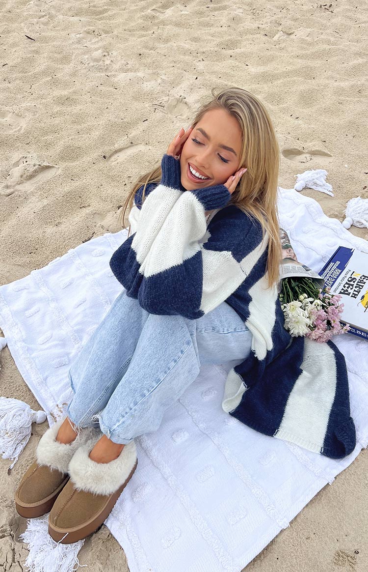 Navy and white chunky knit cardigan with wide block stripes and cuffed long sleeves