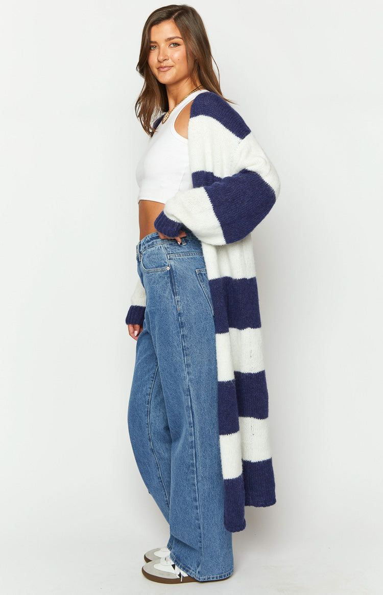Side view of a long blue and white striped knit cardigan with a relaxed fit and long sleeves