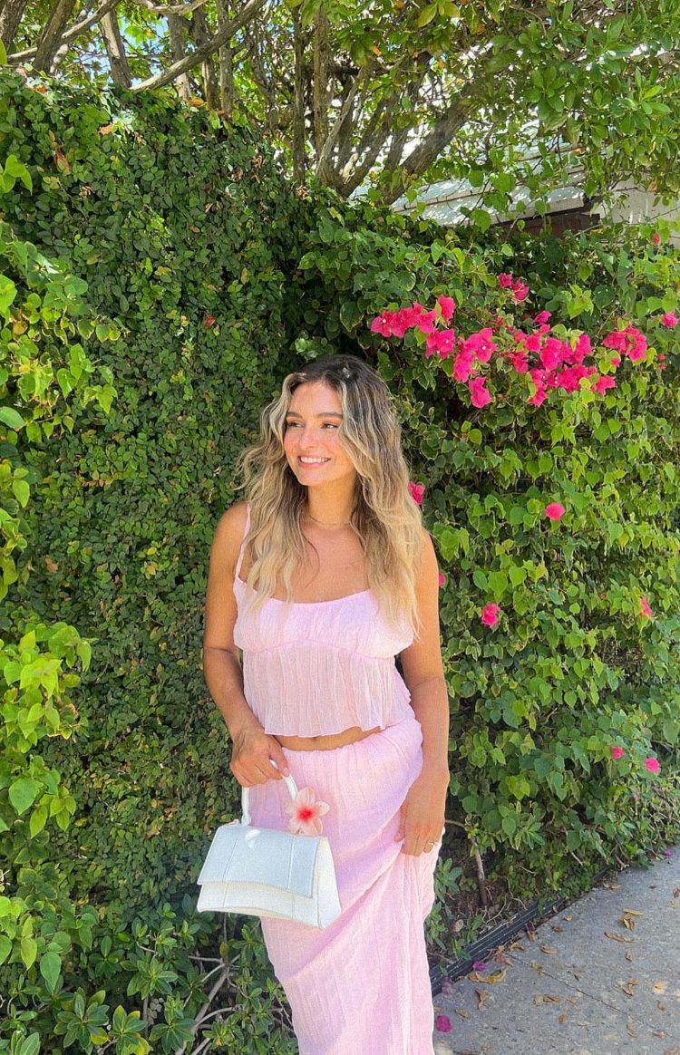 Full length view of a relaxed fit pink crinkled maxi skirt with a flowy silhouette