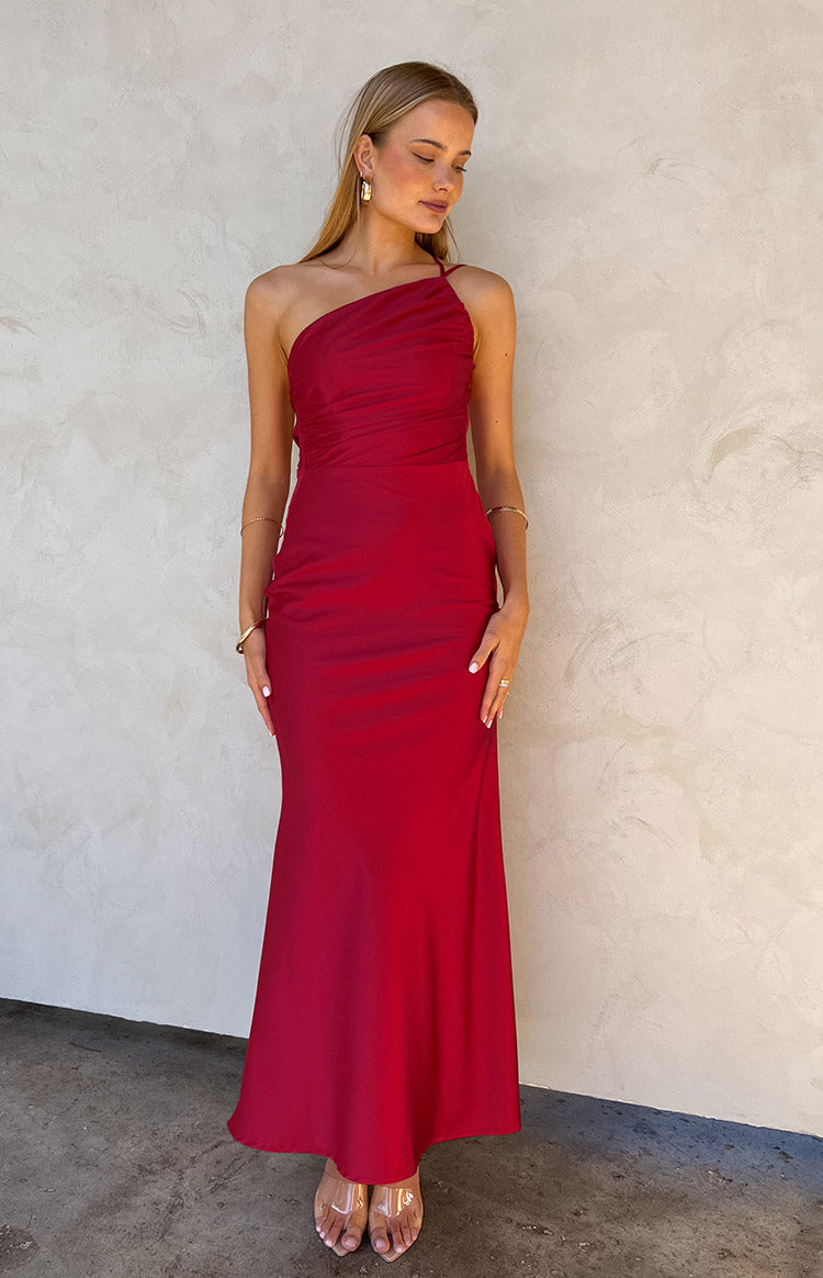 Front view of a red one-shoulder maxi dress with a ruched bodice and a flowing skirt