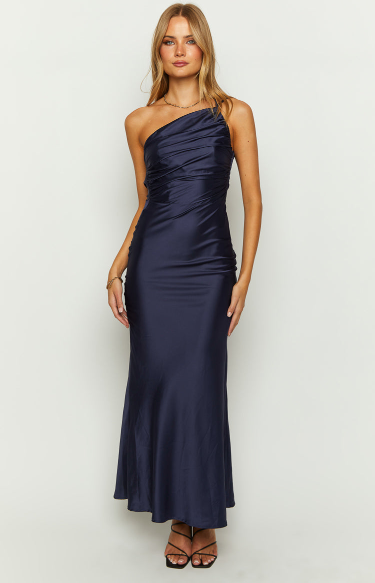 Front view of a navy one-shoulder maxi dress with a draped and ruched bodice and a smooth flowing maxi skirt