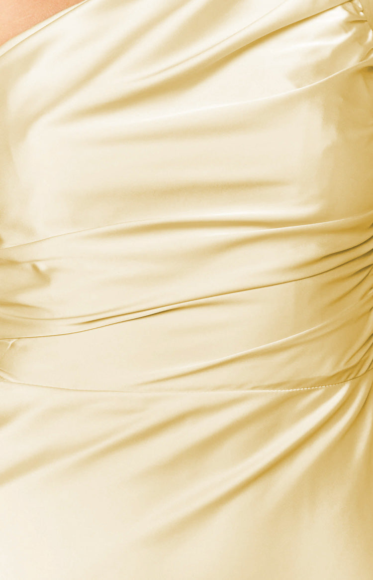 Close-up of the yellow maxi dress fabric with elegant draping and side ruching