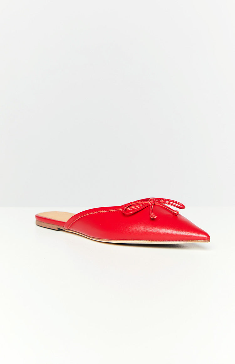 Side view of a ruby red mule flat with a pointed toe and a small decorative bow